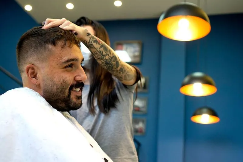 Smiling customer having his hair styled